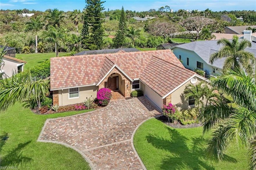 This updated and upgraded 2 bedroom plus den or 3 bedroom home has many delightful features. Full house generator with buried propane tank. Warm wood flooring through the majority of this home.  Kitchen has newer cabinetry, new appliances, lovely quartz counters, and open to everything.  Wonderful family flow allows all to gather together inside or out with tons of space.  There is a large rear yard that abounds in privacy.  Rarely available fenced rear yard is grandfathered in.  Each bathroom has been redesigned with rich tones and practical use. The guest bath has a walk-in tub which will delight young and old alike.  Soaring ceilings, upgraded finishes and fabulous location make this an exceptional buy. The garage has a new epoxy floor with flecks for a fresh new feel. Impact windows and doors are throughout this home with electric storm shutters for the covered lanai area. Lowest priced single family home in Vanderbilt lakes.  Less than a mile to shopping and only 2-3 miles to the beach.  Quiet and peaceful yet close to everything you want and need.