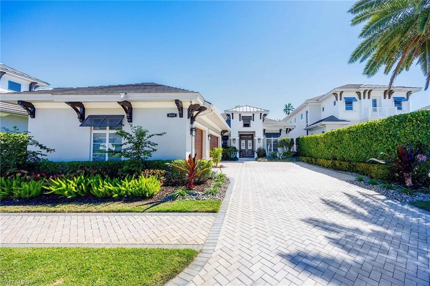 This impeccably maintained, fully furnished former model home—designed by Jinx McDonald Interiors and constructed by award-winning Seagate Development Group—offers a refined blend of craftsmanship and coastal elegance. At 6818 Mangrove Avenue in Naples, this three-bedroom, three-and-a-half-bath residence with a den spans 3,119 square feet under air and 5,268 total square feet. A set of custom double front doors with glass insets introduces the home’s West Indies-influenced design. Inside, the great room features a wet bar with an under-cabinet wine cooler and 10-foot WinDoor pocket sliding glass doors. The gourmet island kitchen includes Bosch appliances, granite and quartz countertops, and Smithport cabinetry. The open dining area is designed for seamless entertaining. The primary suite offers a light-filled retreat with expansive windows and a seating area, a freestanding soaking tub, frameless shower, and custom closet system. Interior enhancements include a Control4 home automation system, premium wood baseboards, solid Timberland doors, Emtek hardware, sound insulation in baths and laundry, and level 5 drywall. The home includes valuable features such as a whole-house water softener, plantation shutters and a whole-house generator. It is offered turnkey furnished—just move right in and enjoy. Outdoor living is elevated with a custom pool, spa and summer kitchen surrounded by a professionally landscaped setting with lighting. The three-car garage includes epoxy flooring. Set in one of Naples desirable areas, the home provides convenient access to state beach parks, fine dining and luxury shopping. This residence combines model-home quality with enduring construction and thoughtful design.