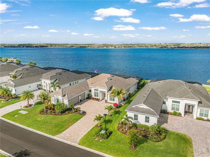 Lakefront luxury with extensive post-construction upgrades in WildBlue—offering a rare opportunity to own a fully customized Bougainvillea with resort-style outdoor living and wide water views.

Located in one of Southwest Florida’s premier master-planned communities, this home delivers an unmatched lifestyle with boating, kayaking, paddleboarding, and some of the best bass fishing in the area right from your backyard. This gas community adds efficiency and convenience to everyday living.

Inside, the thoughtfully designed open floor plan is enhanced by high-end finishes and upgrades throughout. The great room features a striking coffered ceiling with custom millwork and a built-in entertainment wall with a sleek electric fireplace, shiplap accent, and integrated shelving and cabinetry. Designer lighting from Wilson Lighting is featured throughout select areas of the home, adding a cohesive and upscale touch.

A custom enclosed office has been added in place of the original informal dining room, creating a private and functional workspace while maintaining flexibility for future use.

Outdoor living is where this home truly stands out—featuring an expansive covered lanai with approximately 830 square feet under roof, Storm Smart hurricane screens, and a fully equipped summer kitchen with built-in grill, stainless steel hood, granite countertops, and stone backsplash.

The oversized custom pool and spa, finished with premium marble pavers, include a sun shelf and water features—all perfectly positioned to capture breathtaking wide lake views. Professionally designed tropical landscaping completes the private, resort-style setting.

Additional upgrades include an insulated garage with a mini-split A/C system and a whole-house generator, offering comfort, functionality, and peace of mind.
