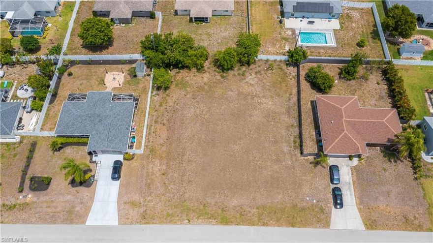 Rarely available TRIPLE LOT in the center of Cape Coral with city water and sewer- 
ALL assessments paid!  This is a great opportunity to build your dream home with a pool  in an established neighborhood.    Minutes to shopping, restaurants with easy access to Fort Myers and the beaches