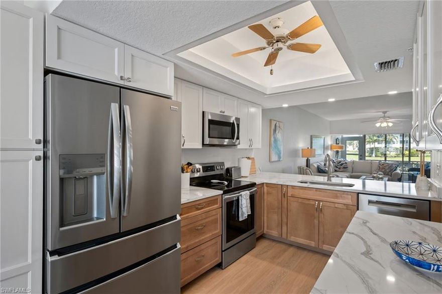 Enjoy peaceful golf course and lake views from this first floor end-unit condo in Breckenridge, offering added privacy, natural light, and easy access. This 3 bedroom, 2 bathroom residence features an inviting layout designed for comfortable everyday living and relaxing surroundings.

The spacious kitchen welcomes you with stainless steel appliances, new cabinetry, quartz countertops, a convenient breakfast bar, and a dedicated dining area just off the kitchen. The generous living room opens to beautiful water and golf course views and flows out to a screened lanai overlooking the lake, a perfect spot to relax and enjoy the scenery.

The primary bedroom includes hardwood flooring and an updated ensuite bathroom with dual vanities and a shower. Two additional bedrooms also feature hardwood floors and share a full bath. Luxury vinyl plank flooring runs throughout the main living areas, and plantation shutters on all windows add style and privacy. A covered carport parking space adds convenience.

Residents of Breckenridge enjoy an active community atmosphere with a wide range of amenities, including bundled golf on an 18-hole executive course, five community pools, tennis courts, pickleball, bocce, and shuffleboard. The clubhouse hosts a full calendar of social events and activities, creating a lively and welcoming environment. The community also offers a dedicated storage area for boats and trailers. Ideally located in Estero, you are just a short drive from Southwest Florida’s beautiful beaches, along with a variety of shopping, dining, and entertainment options.

Don’t miss this opportunity to enjoy the perfect combination of comfort, stunning views, and resort-style living—schedule your private showing today!