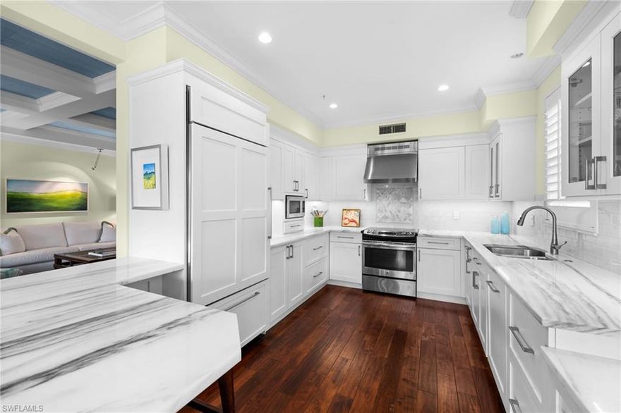 Some homes whisper. This one tells a story—not through words, but through experience. Through the way morning light moves across book-matched marble. Through the quiet confidence of soft-close cabinetry and golf course views that shift from emerald to gold as the day unfolds.
2120 Aberdeen Lane isn’t defined by square footage. It’s defined by intention—the kind that separates a residence from a retreat.
That intention is evident upon entry. Statement wallpaper in the foyer signals thoughtful, design-forward choices. Coffered ceilings introduce architectural depth without excess. Engineered hardwood flows seamlessly toward expansive windows that frame Stonebridge’s redesigned fairways like living art.
The kitchen reveals its sophistication over time. A Miele dishwasher integrates cleanly into custom cabinetry designed for real-world function. Marble countertops with precisely aligned veining bring visual continuity. A built-in window seat—finished with turquoise cushions—overlooks the course, creating a natural pause point for morning coffee or an afternoon reset.
This 2,075-square-foot, first-floor coach home is designed for ease. Impact-rated windows & sliders and motorized roll-down shutters provide peace of mind without sacrificing natural light. Anti-slip porcelain tile balances elegance with practicality, while custom closet systems and linear ceiling vents preserve clean lines and everyday comfort.
Each upgrade reflects careful consideration—nothing added without purpose.
The primary suite overlooks the golf course, offering a calm visual backdrop removed from street activity. The bath continues the home’s design language with dual vanities, coastal-inspired wallpaper, and a thoughtfully proportioned tub-shower combination.
A secondary bedroom and flexible den provide adaptable space for guests, work, or hobbies—proof that well-planned square footage eliminates compromise.
Stonebridge Country Club offers golf, dining, and resort-style amenities within a well-established Naples setting. The community’s layout and design encourage connection while preserving a sense of privacy and calm.
First-floor coach homes with unobstructed golf course views are limited within Stonebridge. This residence presents an opportunity to step into a thoughtfully upgraded home where design, comfort, and setting align.