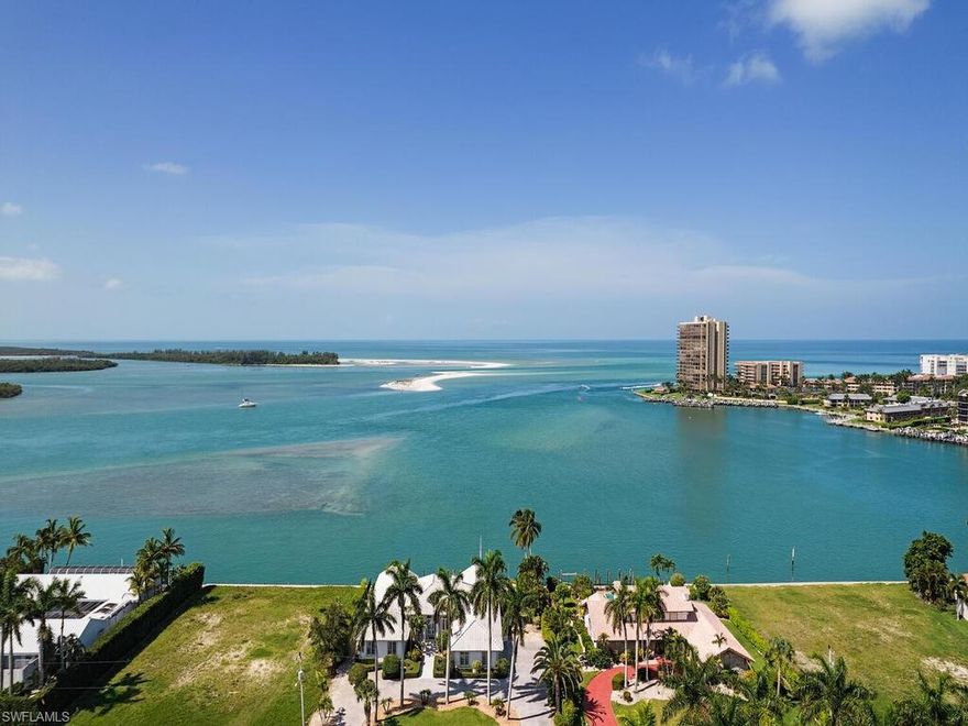 Spectacular property with 125 feet of direct water frontage showcasing spectacular, panoramic views of the the pristine, aqua waters of Marco Island from nearly every room! This magnificent residence with Southern exposure is situated on half an acre and is the epitome of island living. The outdoor living space is designed for entertaining with an oversize pool and multiple lounging areas overlooking the endless, unobstructed waterscape of the Bay just feet to Caxambas Pass and the deep waters of the Gulf of Mexico.  The 125 feet of seawall is ready for your private dock and boat to enjoy fishing and observe dolphins and manatees from your own private residence. The interior of the property has numerous updates including a chef's kitchen with gorgeous quartz countertops, shaker cabinets, and stainless steel appliances. The master retreat features a bay window and sitting area overlooking the water. Feel like you were on your own private resort while being just minutes to Marco Island's shopping, dining, entertainment, and Southwest Florida's worlds famous white sand beaches.