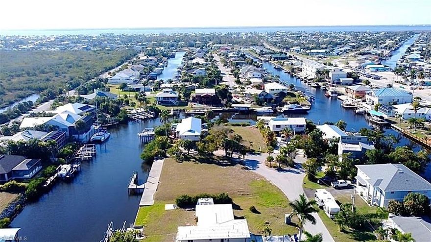 Enjoy the best of Southwest Florida boating from this premium oversized triple Gulf-access lot ideally located just minutes from open water. With no bridges and deep-water navigation, you’ll be cruising toward Fort Myers Beach, the Sanibel/Captiva Islands, and the Gulf in a quick 10 minutes. A private dock is already in place, making it easy to start enjoying the boating lifestyle right away. The generous lot size offers plenty of room to design a custom waterfront home with pool, outdoor living space, and expansive water views. Situated on a quiet cul-de-sac in the heart of St. James City, this property also features a significant amount of fill already in place, saving future building costs. Enjoy a peaceful canal setting with no through boat traffic, plus easy access to marinas, dining, beaches, and the nearby Saint Jude Nature Trail. Great neighborhood for riding golf cart, jogging, and taking scenic walks!