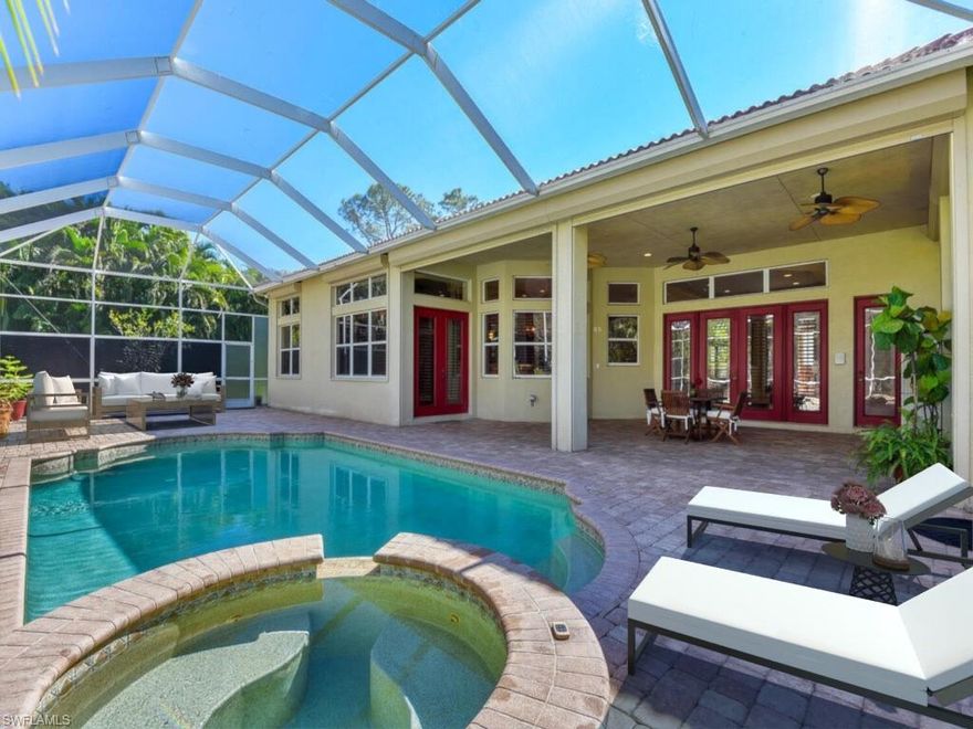 Welcome to your new estate home! This house has just been refreshed from top to bottom with all new interior paint! Follow the paver driveway through the remote control security gates into the beautifully landscaped front yard and around the circular driveway into the large three car garage. Landscape lighting lines the entryway making this home sparkle at night! With 4 bedrooms, 4 full bathrooms and a den this home is spacious & open for all your entertaining dreams to come true! The kitchen features a gas cooktop, kitchen island for additional counter space, a large walk in pantry, and a separate wet bar overlooking the pool & patio. You can even expect the highest quality water with a whole home reverse osmosis system. Enjoy spending time outdoors on the quiet screened in patio and taking a dip in the refreshing salt water pool. This home is equipped with a standby generator powered by a 500 gallon propane gas tank that has the ability to run electricity to the entire house, and is fully protected by hurricane shutters and impact rated garage doors. This masterpiece sits on 2.5 acres, is just minutes to all that Naples has to offer & is now zoned for Barron Collier High School!