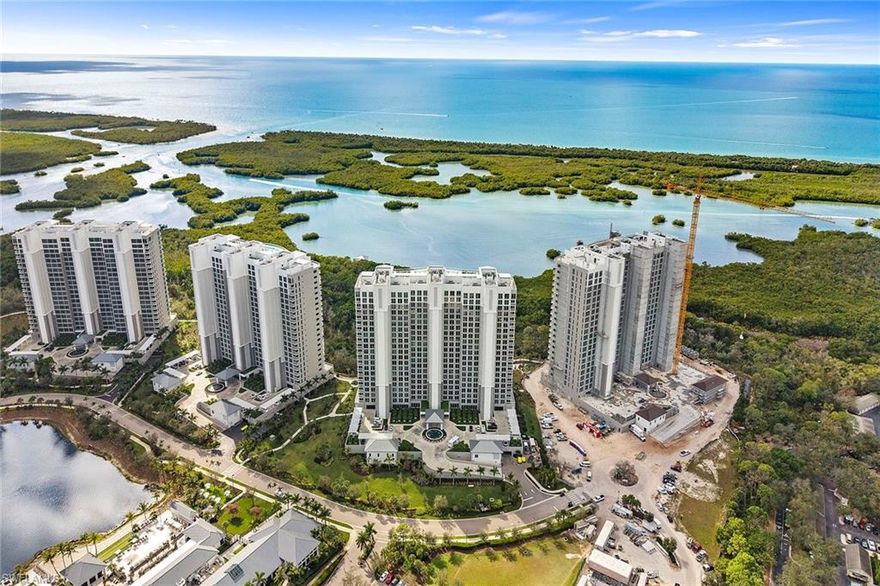 Stunning Kalea Bay Tower 400, 8th-floor luxury residence offering glorious Gulf views from this precious corner unit. This new-construction condominium is located in one of Naples’ most prestigious and sought-after communities. The four-bedroom, four-bath residence embodies elegant sophistication with modern, timeless features, including gleaming white porcelain marble tile throughout, an amazing custom-designed primary bedroom closet, and exceptional, tastefully curated design with international appeal. This open concept floor plan showcases sparkling designer lighting, floor-to-ceiling impact glass that frames spectacular sunsets, mangrove preserves, and twinkling city lights.
The chef’s kitchen is equipped with Wolf and Sub-Zero appliances, natural gas range, quartz countertops, custom cabinetry, oversized island and a butler’s pantry with prep sink. The spacious great room opens to a wraparound lanai with glass railings and southwest exposure, offering unobstructed indoor-outdoor living.
The primary suite overlooks the water and features a custom walk-in closet and a spa-inspired bath with dual quartz vanities, a walk-in shower and soaking tub. The residence includes a private elevator foyer, solid-core interior doors and ample storage.
Tower 400 amenities include a rooftop fitness center, negative-edge pool, sky lounge, grilling area and a 7,500-square-foot rooftop terrace with sweeping views. The residence also comes with assigned garage parking  and a secured lobby with an on-site manager and 24-hour security.
Ownership includes full access to the 100,000-square-foot Club at Kalea Bay, featuring three resort-style pools, a state-of-the-art wellness center, two open-air bars, the Driftwood Cafe and Salt and Oak Restaurant, tennis and pickleball courts, a beach shuttle and guest accommodations at the Bay Cottages. Located in North Naples, Kalea Bay is minutes from white-sand beaches, upscale shopping and gourmet dining.
This residence is the ideal blend of coastal luxury, architectural sophistication and resort-style living.