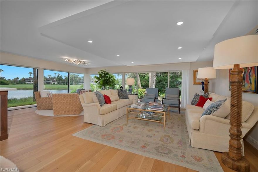 Welcome to this contemporary first-floor end unit with expansive lake-to-golf course views overlooking Wilderness's 18th green. Completely redesigned, this home epitomizes luxury living with its meticulous attention to detail. Seamlessly combines modern elegance, comfort, and warmth. Luxuriate in the exquisite French oak flooring, upscale designer lighting from Serena and Lily in the dining area and an Ed Koehler fixture in the sitting area, neutral-toned quartzite Taj Mahal with a suade finsh countertops, and custom cabinetry in every room, adorning this home with comfort in every detail. The open layout is flooded with natural light from over 40 feet of wrap-around sliders, seamlessly connecting two distinct living areas with the spacious dining room and kitchen. The chef's kitchen has custom cabinets, under-counter lighting, and high-end appliances, raised cabinetry, modern backsplash, and extra storage, including a walk-in pantry, creating an ideal space for culinary creativity. The third bedroom has been converted into a comfortable office/family room with a built-in desk, grasscloth wallpaper, and floating shelves. The elegantly redesigned bathroom showcases double sinks, a frameless shower enclosure, and upscale light fixtures. The patio provides a serene lakefront retreat with generous space for dining and entertaining. Step outside to enjoy covered parking, a golf cart, and a generously sized golf cart garage that provides ample additional storage. Residents have exclusive access to the newly constructed state-of-the-art 5-star Clubhouse and practice facility, making this property a golfer's paradise. A golf cart and dedicated cart garage are included, conveniently located next to your assigned covered parking. Set within a stunning 200-acre gated community, you'll enjoy beautifully landscaped grounds and mature trees lining the roads. This community offers unlimited golf on an 18-hole Arthur Hills course, as well as five inviting pools, four tennis courts, bocce, croquet, and a dog park. This condo is a true gem, just minutes from the vibrant shopping and dining of 5th Avenue and Old Naples. Purchase of a Wilderness Country Club membership is required and immediately available, offering you an effortless transition into this luxurious lifestyle. Don’t miss your chance to make this stunning condo your new home!