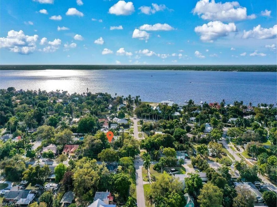 Discover a rare opportunity to own a charming river district residence that blends character, functionality and future potential in one of Fort Myers’ most desirable areas. This thoughtfully laid out home offers two comfortable bedrooms plus a versatile den and a well appointed full bath, creating flexible living spaces ideal for a home office, creative studio or additional lounge area. Natural light fills the interior, highlighting a warm and inviting atmosphere while maintaining a practical flow for everyday living. The main living areas feature 100 year old original floors, impact windows and a working wood burning fireplace, combining historic charm with modern resilience while providing a comfortable setting for relaxing or entertaining, complemented by a layout designed for ease and efficiency. The kitchen offers ample space to customize and enhance, making it a perfect canvas for buyers looking to add personal value and style. Situated on a generously sized homesite, the outdoor space provides room to expand, garden or design your own private retreat, with mature surroundings that add both shade and a sense of established charm. The location places you just minutes from the historic river district, dining, shopping and waterfront parks, while still offering a quiet residential feel. Whether you are seeking a primary residence or a long term investment in a steadily growing area, this property presents a compelling combination of location, flexibility and potential, making it an excellent choice for buyers looking to secure a foothold in the Fort Myers market.