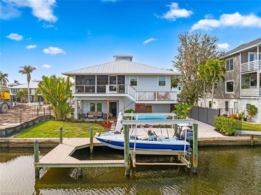 WHAT ARE YOU WAITING FOR?  Priced over $75k below certified appraised value.  High-End Gulf Access Gem in Naples – Coastal Living at Its Finest! Calling all fishing and boating enthusiasts! This custom-renovated, move-in-ready coastal retreat offers the perfect blend of luxury and functionality, with 3 bedrooms, 2 full baths, with addition flex room, storage room and garage on ground floor. Transferrable Flood Insurance of only $1,400 per year! This home is located in a prime location in a highly sought-after A-rated school district. Step inside to discover the timeless elegance of bamboo and travertine tile floors, soaring vaulted ceilings, and abundant natural light that highlights the stunning canal views. The open-concept design is thoughtfully crafted, perfect for both relaxing and entertaining. Completely renovated kitchen, a chef's dream featuring stainless steel appliances, induction cooktop with Viking downdraft vent, three pull-out pantries for ultimate organization, and built-in stained walnut bench seating with hidden storage. The luxurious primary suite is a true sanctuary, offering custom-designed walk-in closet cabinetry with walnut plywood, spa-like bath with Taj Mahal granite vanities, a soaking tub, and a large glass-enclosed shower. Step outside and embrace the Florida lifestyle on your back screened deck, complete with shimmering canal views, a soothing hot tub, and lush, tropical landscaping. A private dock and boat lift make Gulf access effortless, allowing you to explore the waterways at your leisure. Additional features include impact-resistant doors and windows for peace of mind, on-demand water heaters, durable metal roof, beautifully manicured landscaping and more! Ideally located, this home places you within minutes of Naples' best dining, shopping, and entertainment. Whether you’re enjoying a day on the water or relaxing in your coastal oasis, this property offers the ultimate Naples experience. Don’t miss your chance to own this stunning Gulf-access home—schedule your private tour today!
