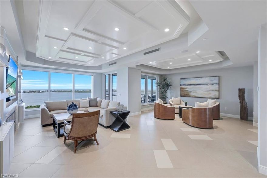 This ABSOLUTELY GORGEOUS fully furnished 3+ den home overlooking the Estero Bay & Gulf of Mexico is pure sophistication & luxury! Located in the desirable Tavira high rise in Bonita Bay, "move right in" to this cosmopolitan, exquisitely updated home in the sky. This home has all - 3BR+den/3 BA, distinctive finishes, a private elevator entryway, & a large screened lanai w/outdoor kitchen & 2 addl open air balconies. No expense was spared with the beautifully designed & modern interior - from the ceiling details to the state of the art kitchen. Features include elegant white kitchen cabinets, "leathered" quartz counter-tops, electric fireplace, custom backsplash, built in wine cooler, lighting upgrades, intricate ceiling treatments, split bedrooms, intimate spaces & so much more. Entertain friends & family in this immaculate home or treat them to the rooftop terrace! Enjoy Bonita Bay's award winning beach park, nature trails & optional amenities including golf & tennis, fitness center & marina. Newly redesigned common areas thru-out Tavira! Do not hesitate as homes in Bonita Bay w/such elegant finishes are RARE! Be sure to view the stunning accompanying video of this home!