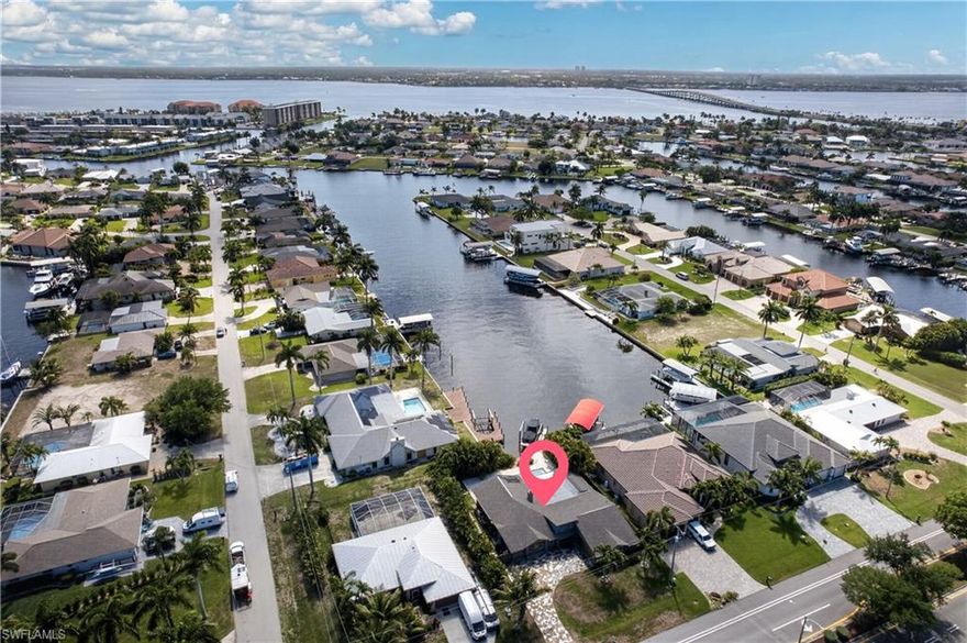 200’ WIDE DIRECT GULF ACCESS CANAL – MINUTES TO OPEN WATER! This exceptional waterfront property offers the boating lifestyle serious boaters are looking for, with quick direct access to the Caloosahatchee River and the Gulf of Mexico. Enjoy quick and easy navigation from your private dock featuring a BOAT LIFT and walk-around dock, making it effortless to step aboard and be on open water within minutes.

This 2,600+ sq. ft. POOL home features 3 bedrooms, 2½ bathrooms, and a DEN with travertine flooring throughout and an open GREAT ROOM floor plan designed for comfortable coastal living. The large contemporary kitchen with oversized island and breakfast bar open to the main living space

The spacious master suite addition (2009) is a private retreat with vaulted ceilings, a stone-faced fireplace, and a luxurious en-suite bath featuring a custom soaking tub and walk-in shower.

Outdoor living is equally impressive with a pool featuring a swim shelf and expansive travertine pool deck, perfect for relaxing after a day on the water.

Recent updates include new replumb (2023), lanai roof (2024), and newer A/C. Located in SE Cape Coral, this home also offers convenient access to shopping, dining, and the Cape Coral Bridge.

Wide canal. Direct Gulf access. Minutes to open water. A true boater’s location.