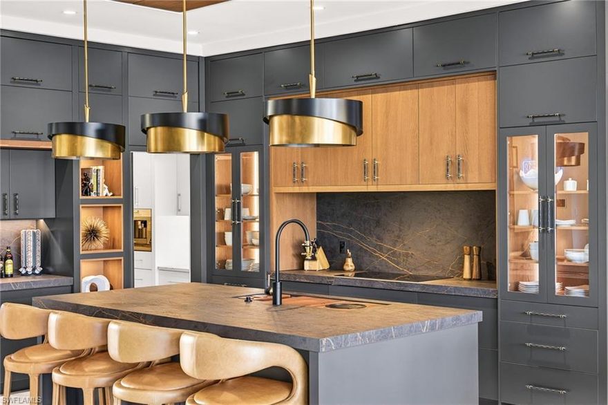 Bold. Brilliant. Unmatched.

Welcome to “The Crown Jewel” — an award-winning, 3,600-square-foot statement custom home by Koogler Homes, built to prove what’s possible when craftsmanship meets obsession-level detail. Positioned on over 260 feet of canal frontage in Cape Coral and awarded CCCIA Builders Showcase Top Honors and BIA Builders Showcase of Homes- Superior Homes Award, this residence isn’t just finished — it’s curated, engineered, and intentionally different.

Step inside and the “wow” starts immediately: museum-grade entry art, a showpiece bar with a two-story illusion created by a mirrored ceiling, and a great room grounded by dramatic, oversized tile and contrast-rich finishes. And because real luxury is also livable, the main kitchen is designed for gathering, while a hidden “back kitchen” handles the heavy lifting — complete with gas cooking, extra refrigeration, ample prep space, and even built-in pet bowls to keep daily life seamless.

Every ceiling is its own architectural moment — and the primary suite takes it further with a custom detail that casts a soft, warm glow that feels straight out of a boutique hotel. The layout is equally thoughtful: three bedrooms plus a flex/game room (ideal as a fourth sleeping space), with guest suites that live like private retreats.

Then the home opens up — literally. A full wall of bi-fold glass creates a 30-foot opening to an outdoor living environment that’s in a category of its own: dining, lounging, full outdoor kitchen, pool and spa, putting green, and a zero-entry pool ramp designed for comfort across every season of life. The signature moment is the sunken chickee lounge — seating for 20, a linear fire feature, and a custom 135-inch TV, with additional pool-side seating built right into the water so the whole party stays connected.

This is the kind of home that doesn’t follow trends — it sets them. And if you’re looking to commission a true one-of-one in Southwest Florida, this is your blueprint.