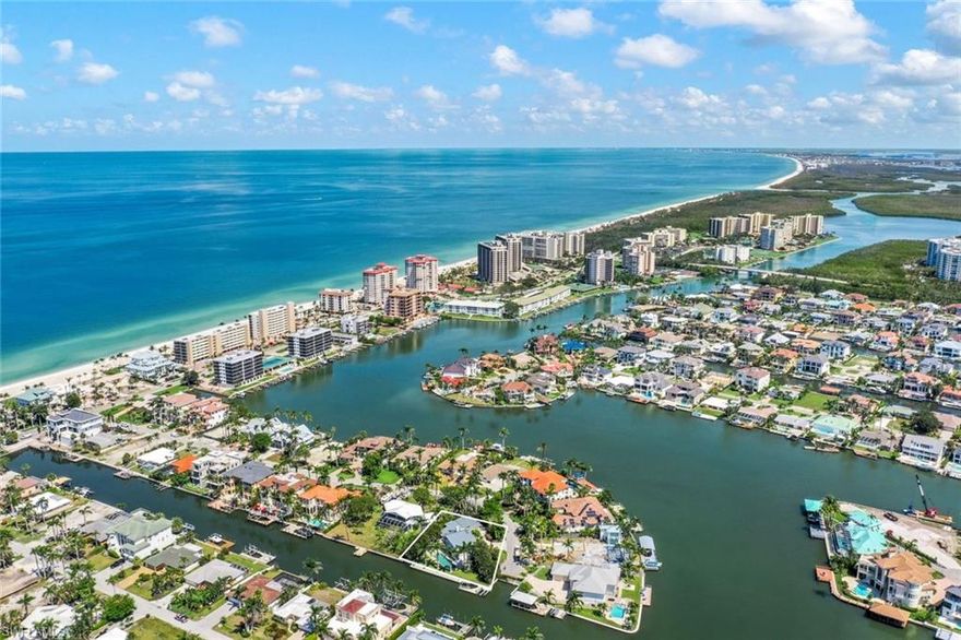 Live the ultimate Naples lifestyle in one of the city's most desirable and exclusive locations. This oversized lot, a rare find at the end of a quiet cul-de-sac, offers desirable southern exposure and boasts over 140 feet of seawall. Uniquely, this is one of just eighty-three lots that provides the luxury of both boating from your backyard and walking to the pristine waters and sugar-white sands of Vanderbilt Beach.The current residence on this lot has sustained hurricane damage, presenting a unique opportunity. The new owner may choose to tear down the existing structure and build their dream home from scratch, or they might decide to restore the current residence, which would include three bedrooms and a den.This property is ideally situated within walking distance to La Playa and a short drive from the Ritz Carlton, Mercato shops, and Waterside. Don't miss the opportunity to claim this extraordinary waterfront property and experience the privilege of residing in this exceptional location!