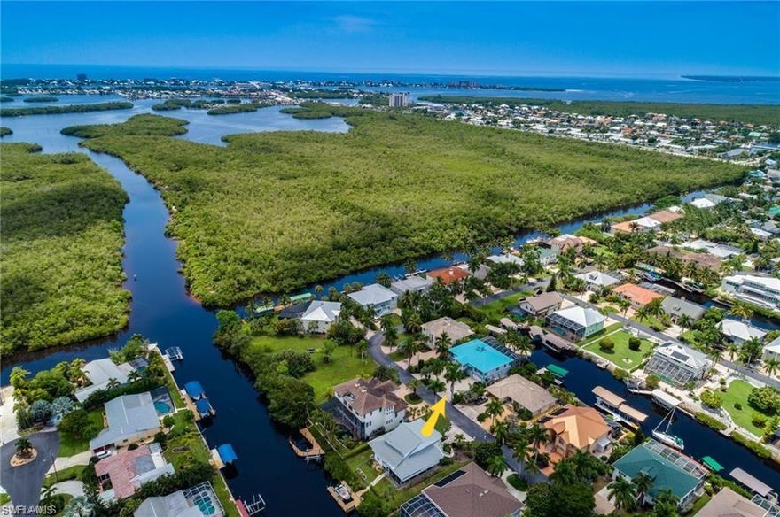 Beautiful Tropical Style Home in Fort Myers Beach Best kept Secret. A Boaters Paradise Palm Isles. Highest Quality Construction and Upgrades. Second Floor is Pre Cast Concrete slabs. This Home has been meticulously maintained. Great Room Bedrooms and Kitchen all have unobstructed water Views. There are 5 Bedrooms and 4 1/2 Baths. The master bedroom suite is open to the waterfront via windows and a sliding glass door to the deck. Also features a walk-in closet with a shelving system. The master bath features a large glass enclosed shower, a garden tub, a dual vanity, indirect lighting and an enclosed toilet. The nicely-equipped kitchen features a wet bar island and opens to the formal dining room and Kitchen Nook. There is a 620sf upper deck that provides generous room for outdoor gatherings and overlooks the pool and waterfront. Tropical Pool area with Boat Dock and 10,000lb Covered Lift with fresh water and electrical service. The enclosed lower level is completely under air and includes a amazing Sports Bar. Functioning Cupola floods the Great Room with natural sunlight. Take a look at the Virtual Tour.