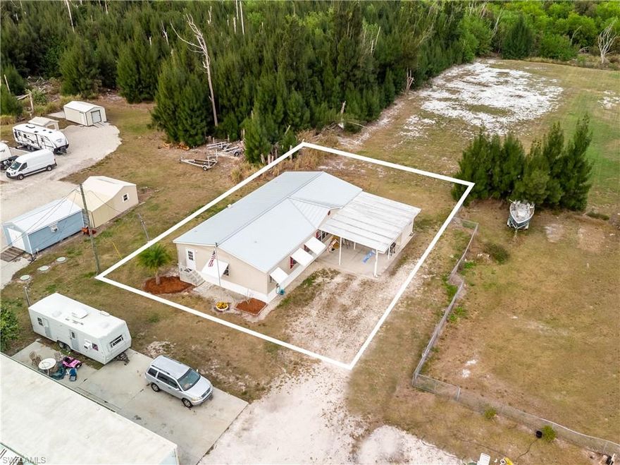 Spacious 1,800 sq ft Flamingo Bay 3-bedroom, 2-bath home with a den, offering comfort, privacy, and peace of mind—never flooded during any storms. The backyard backs up to an open area adjacent to church property, providing a quiet, private setting. Inside, you’ll find a desirable split-bedroom floor plan with walk-in closets, vaulted ceilings, with tile and laminate flooring throughout. The home features a durable metal roof, new stove, dishwasher, and in-home laundry with washer and dryer. A large storage room adds extra functionality, while the carport includes a relaxing sitting area. The HOA offers voluntary membership with a one-time $500 fee paid at closing and an annual fee of $275 per person, granting access to the pool, clubhouse, and social activities. A boat ramp key is also available at a low cost. This is a great opportunity to own a well-maintained, comfortable home in a welcoming community. Perfect for fulltime or vacation destination!