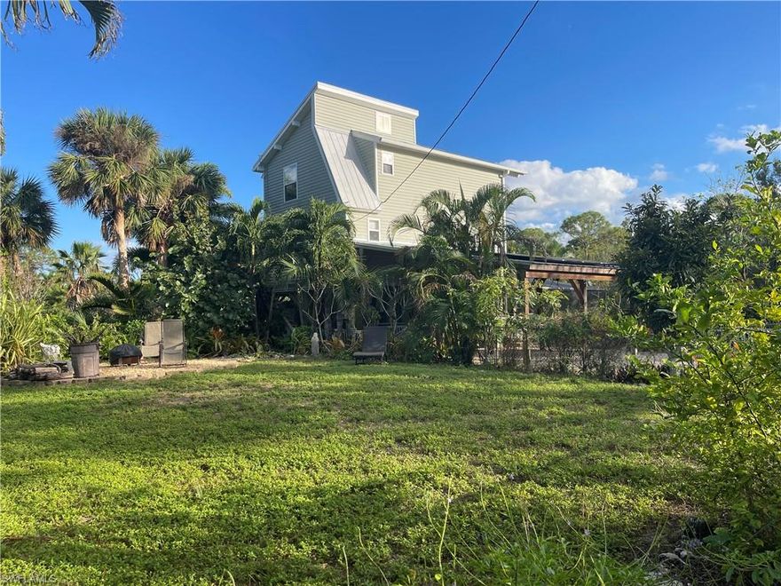 Wind and Flood Coverages are now available. Possible owner finance with 1/3 down. Private Tropical Estate with Cottage and Studio Workshop on 10 Acres. Step into a world of tranquility and beauty with this incredible 10-acre property, a true private retreat offering luxury, income potential, security and breathtaking natural surroundings. Located amid Palm Groves and Mango Groves on the northeast corner of the island. This property can be a perfect off-grid situation with a major solar power system with ample battery backup to keep the lights and refrigerator on for days. Water storage tanks and RO water filtration in main house and cottage. New A/C Systems in all buildings. Metal roofing on all buildings. 
The main home is perfect for relaxation and entertaining. Cozy screened porch overlooks the pond, bridge, waterfall and the lush tropical vegetation. Large lower-level screen room featuring a screened, heated salt pool with hot-tub. Also, an additional screened greenhouse for plants, flowers, veggies. 
At the heart of the property lies a picturesque pond, complete with a waterfall and a charming bridge leading to a small central island—a perfect spot for peaceful reflection or a unique entertaining space. The entire property is fully fenced, gated and secured, with a smaller fenced area at the main house for your dogs. For added value, a charming rental cottage offers a source of income or cozy accommodations for guests. Other practical amenities include a workshop building that can serve as a barn, studio or family business use. Three-car carport, and two storage sheds. The land is dotted with over 12 mango trees, adding a lush, tropical touch to your surroundings. Located on a road with no through traffic, this estate offers unparalleled privacy and serenity. The cottage income has paid all of current owners overhead for years. Excellent Biking Area with a bike path that stretches the entire island. Close to marinas and restaurants. Fresh farm eggs and veggies can be purchased locally. 
Whether you’re seeking a peaceful escape, a working property, a family secured compound or a smart investment, this stunning estate delivers on every level. This property could be split. Schedule your private tour today! Owner is a Florida Real Estate Broker and has lived there for 15 years.