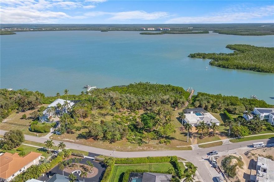 Opportunities like this are incredibly rare. This prestigious two-acre estate in Marco Island's sought-after Estate section offers approximately 260 feet of Barfield Bay frontage with nearly 300 feet of depth and up to 21 feet of elevation, making it one of the highest and most unique properties in Southwest Florida. Among majestic black, red, and white mangroves and dogwoods, this property is a nature enthusiast’s haven, where a custom-designed boardwalk could weave through the tranquil landscape and has the ability to construct buildable docks with permitting, both lots. With natural sand dune contouring, the site offers endless possibilities for an architect's creativity, imagine a luxurious residence with multiple elevations, walkout basements or under-home parking, all above the floodplain and requiring no flood insurance with both lots in flood zone X. This expansive property is ideal for those seeking extreme privacy and seclusion, with the potential for gated access and landscaping to create a hidden retreat. Enjoy all-day viewing of vibrant wildlife and stunning bayfront vistas, and immediate direct water access, ideal for world-class fishing, boating, and exploring Marco Island's 10,000 Islands and the Gulf of Mexico. Two separate one-acre adjoining lots that can be sold together or individually. Parcel IDs: 841-25830280004 and 849-58106640002. Whether you envision a private waterfront estate or a creative architectural masterpiece, this property represents a once-in-a-lifetime opportunity to own a significant piece of Southwest Florida real estate. Schedule your private tour today to experience the unparalleled beauty and potential of this extraordinary property.