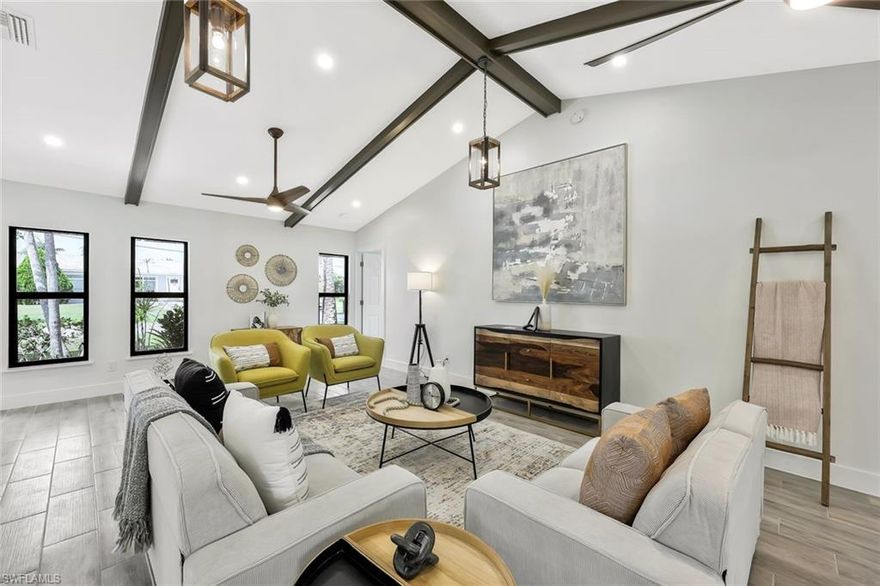 Enjoy the freedom of living your way—with no HOA! Nestled in a quiet, established neighborhood surrounded by lush, mature trees, this beautifully renovated 2-bedroom, 2-bath home offers the perfect blend of privacy, comfort, and classic charm.

From the moment you arrive, a newly designed stone walkway leads you to a peaceful retreat that instantly feels like home. Step inside to discover a bright, open layout enhanced by impact-resistant windows and doors, stylish tile plank flooring, and rustic vaulted ceilings with exposed beams. Every detail has been thoughtfully updated, from the elegant recessed and drop lighting to the ceiling fans that add both comfort and character.

The chef-inspired kitchen features a spacious island with built-in oven and hood, quartz countertops, and stainless steel appliances—perfect for everyday living or hosting guests. Both bathrooms shine with modern upgrades, including frameless glass showers, warm wood cabinetry, and sleek new vanities.

Enjoy the Florida lifestyle year-round in the large screened lanai and fully fenced backyard, ideal for entertaining, relaxing, or soaking in the natural beauty that surrounds you. The breezeway offers additional covered outdoor space and a second stone walkway, creating a seamless indoor-outdoor flow.

Whether you’re seeking a peaceful full-time residence or a seasonal escape, this tranquil oasis is conveniently located just minutes from Southwest Florida International Airport, local dining and shopping, and the region’s world-famous Gulf beaches.