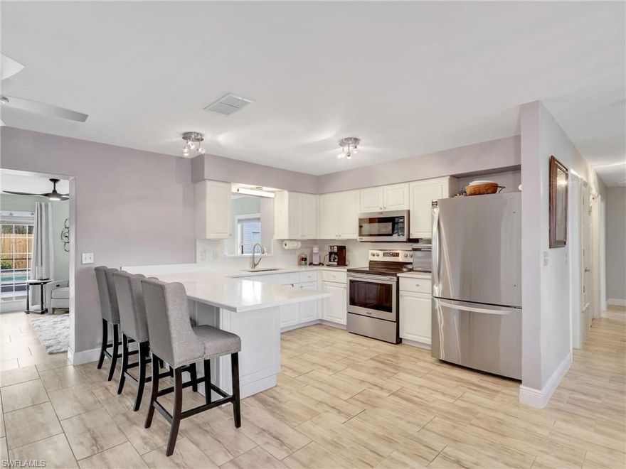 SALTWATER POOL HOME - Ideally located just minutes from dining, shopping, and the white-sand beaches of Sanibel and Fort Myers in X flood zone (no flood insurance required). This beautifully updated 3-bedroom + den, 2-bath home is designed for living the Florida lifestyle without HOA fees. The open-concept layout flows seamlessly to a private fully fenced backyard oasis featuring a massive 30’ x 16’ sparkling saltwater pool, two storage sheds, and a spacious screened lanai with an electric retractable shade. This home is perfect for relaxing, entertaining, and enjoying SWFL weather year-round. Thoughtfully upgraded throughout, this move-in-ready home boasts a recently remodeled master bath, plus a kitchen with quartz countertops, newer stainless steel appliances, stylish lighting and fans throughout, recently replaced hot water heater, pool equipment updates and so much more. Ask for the full list! With generous storage in the garage, plus a hobby room with a sink, front lawn irrigation, and the convenience of a circular driveway for extra parking, every detail has been considered. Nicely updated throughout so you can simply move in and enjoy, or take advantage of this exceptional opportunity to own an investment or rental property.