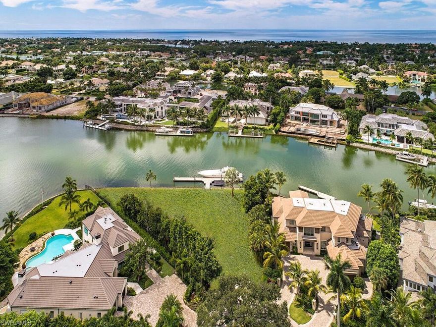 Exceptional and rare, estate lot showcases 238 feet of water frontage nestled at the end of a quiet cul-de-sac with beautiful wrap around wide water views of Galleon Cove.  A 100 foot concrete floating dock is currently in place and is positioned to the side to not block the long, wide water views. Architectural plans designed by Jon Kukk for an 8,200 square foot residence are available.  Port Royal Club Membership Eligibility.