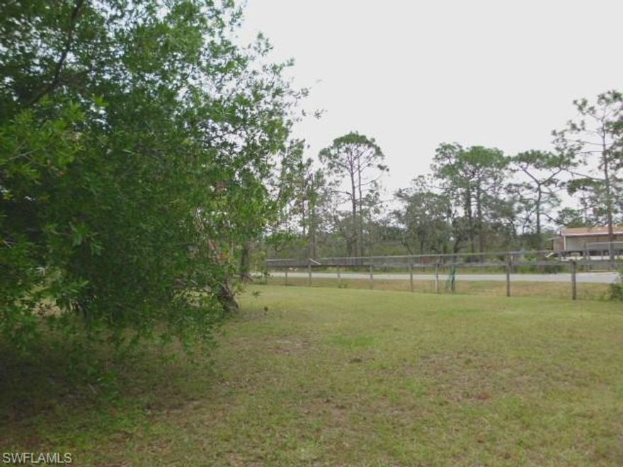 Perfect peaceful getaway this 2.40+/- acre property could be yours today!  Paved access, fully fenced, circle drive, nice pond and several oak trees.  The 1990 mobile home is given no value (Irma damaged).