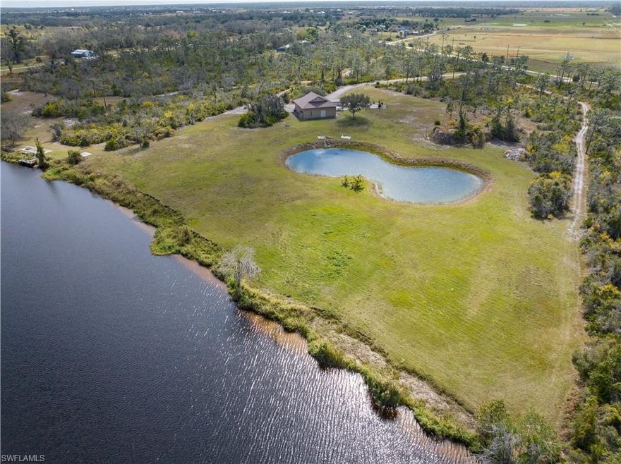 Welcome to 37841 Washington Loop Rd, Punta Gorda, FL 33982! This stunning property offers the perfect blend of natural beauty and modern convenience, located just a short 10-minute drive from downtown Punta Gorda. With expansive acreage, this treasure of a property offers water view of Shell Creek, allowing for serene water adventures right from your doorstep. Whether you enjoy kayaking, fishing, or simply taking in the tranquil surroundings, this location has it all. One of the highlights of this property is the 2200 square foot on-site garage building, complete with a full kitchen and bathroom. Designed to accommodate RVs, Horses and water activities, this versatile space provides ample storage for all your outdoor toys and equipment. Constructed from durable CBS block and a metal roof  for enhanced safety and efficiency, you can rest easy knowing your belongings are secure. Additionally, this property features stables, perfect for equestrian enthusiasts or those looking to bring their horses along for the adventure. All utilities on site for existing and future residence.  Don't miss out on the opportunity to own this beautiful slice of Southwest Florida. Schedule a showing today and experience the charm and potential of 37841 Washington Loop Rd!