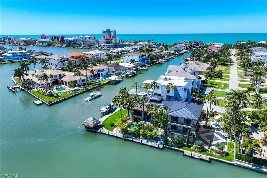 Offered for the first time, this extraordinary waterfront residence at 290 Channel Drive presents a rare opportunity never before available and impossible to replicate in one of Naples desirable coastal enclaves. On a prime southeast corner lot in the Vanderbilt Beach neighborhood, and only one block to the beach with dedicated access. A light-filled home thoughtfully designed and curated by its original owner, an artist with global perspective, it reflects an organic, modern and timeless aesthetic standing apart from traditional Naples design. Warm natural materials, custom architectural elements and quality finishes create a sense of balance and quiet sophistication throughout the home. Abundant and mature landscaping provides privacy and serenity, enhanced by a rare, oversized and grassed yard. The home features a three-level floor plan, complemented by a three-car garage and private elevator. The second floor serves as the heart of the home, featuring a gourmet kitchen, defined yet connected family, living and dining areas, as well as the primary suite. A dedicated workout room integrates wellness into everyday living. The third floor features an additional family area and two guest rooms. The expansive waterfront and dock, with a prominent overwater Chickee, offer shade and endless enjoyment of the activity and sea life of Vanderbilt Channel. A waterside pool with elevated spa, together with Gulf access boating, completes this tropical retreat. This residence must be experienced in person, as its architectural depth, spatial flow and nuance extend far beyond what photography, video or written description alone can convey. Just minutes to Vanderbilt Beach, La Playa Beach Club, The Ritz-Carlton and new private Paraiso beach club. Entertainment, upscale shopping and dining are conveniently near the Mercato and Waterside Shops.
