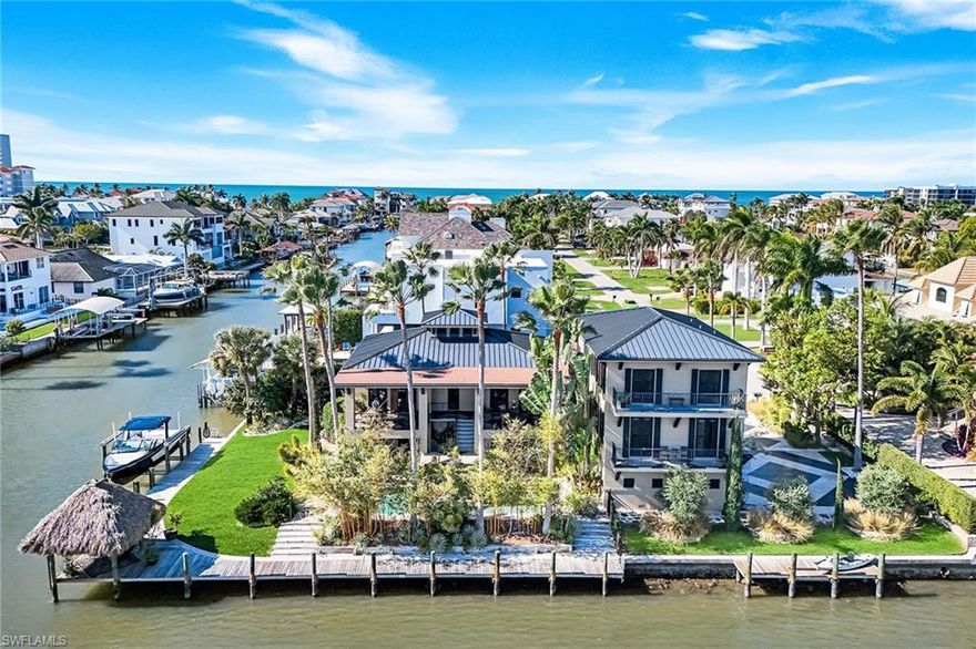 Offered for the first time, this extraordinary waterfront residence at 290 Channel Drive presents a rare opportunity never before available and impossible to replicate in one of Naples desirable coastal enclaves. On a prime southeast corner lot in the Vanderbilt Beach neighborhood, and only one block to the beach with dedicated access. A light-filled home thoughtfully designed and curated by its original owner, an artist with global perspective, it reflects an organic, modern and timeless aesthetic standing apart from traditional Naples design. Warm natural materials, custom architectural elements and quality finishes create a sense of balance and quiet sophistication throughout the home. Abundant and mature landscaping provides privacy and serenity, enhanced by a rare, oversized and grassed yard. The home features a three-level floor plan, complemented by a three-car garage and private elevator. The second floor serves as the heart of the home, featuring a gourmet kitchen, defined yet connected family, living and dining areas, as well as the primary suite. A dedicated workout room integrates wellness into everyday living. The third floor features an additional family area and two guest rooms. The expansive waterfront and dock, with a prominent overwater Chickee, offer shade and endless enjoyment of the activity and sea life of Vanderbilt Channel. A waterside pool with elevated spa, together with Gulf access boating, completes this tropical retreat. This residence must be experienced in person, as its architectural depth, spatial flow and nuance extend far beyond what photography, video or written description alone can convey. Just minutes to Vanderbilt Beach, La Playa Beach Club, The Ritz-Carlton and new private Paraiso beach club. Entertainment, upscale shopping and dining are conveniently near the Mercato and Waterside Shops.
