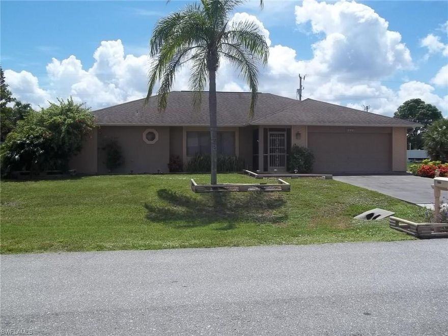 Great Buy! Well maintained 3/2 in established neighborhood close to downtown Cape Coral. Includes all appliances plus washer & dryer. Large walk-in closet in master bedroom. Indoor laundry room. 13x39 enclosed lanai. Storage shed. Oversized garage w/ pull  down attic stair case & garage door opener. Sprinkler system. Water & sewer paid. Plenty room for a pool.