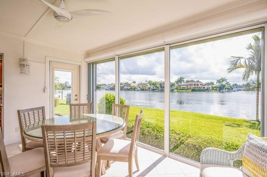 Welcome Home! This updated unit is in Harborside Gardens, a wonderful Moorings bay front community just steps to the white sandy beach right across the street. Located on the first floor, it is an end unit with a garden style entrance so it feels like your own private home, with a spectacular bay view. 
Enjoy casual elegance created by updated kitchen and baths, all redone to perfection. Recently new stainless steel appliances, and new A/C in 2019. Updated countertops, recessed lighting, hi-impact windows, crown molding , remote controlled lanai window shades, plantation shutters, paddle fans, walk-in closets and pretty flooring all add to the tasteful coastal decor. This recently painted home includes interior washer/dryer for your convenience. An outdoor patio is a perfect spot to enjoy a cup of morning coffee or a glass of wine as you watch the dolphin playing in the bay!
The community offers newly painted buildings, a boat pavilion, boat and kayak docks for lease, large heated pool, club room, laundry facility, car port with storage, BBQ's beautiful gardens and green space, and social activities, all close to the Venetian Village with excellent dining and shopping.