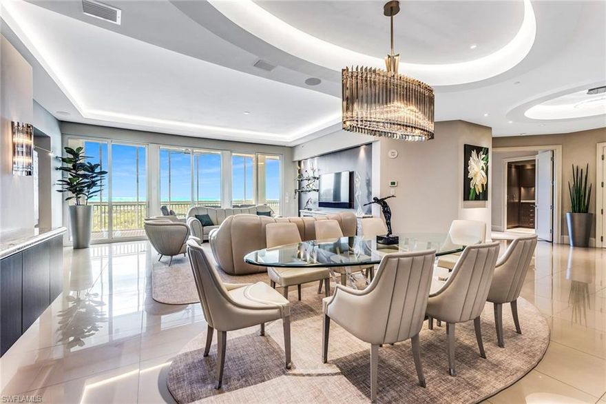 Prepare to be impressed as you step off the private elevator into this show-stopping contemporary residence on the 8th floor at Aqua. Sleek 24x24 inch glass tile, custom light fixtures and a 12-foot long fireplace add warmth and sparkle to this amazing home. The kitchen is re-mastered for entertaining on a grand scale with a 2-sided walk-through wine room, high end appliances and additional prep space. Exceptional orientation allows you to enjoy your morning coffee on the sunrise balcony or catch the sunset over the Gulf on the Marina-side lanai equipped with gas grill. The elegant Master Suite has built-in furnishings, custom his and hers closets and a spa bath with flush granite walls and oversized shower. Guests will enjoy perfect privacy in their luxurious en-suite guest room with beverage center. The 3rd bedroom provides a fabulous workspace with custom built-in cabinetry and partner's desk. Fully automated, every room has Lutron dimming and scene controls, remote blinds and a state-of-the-art audiovisual package. The new wave in luxury towers, Aqua residents enjoy 24 hour concierge service, gym, spa, private theater, 3 guest rooms, virtual golf and more.