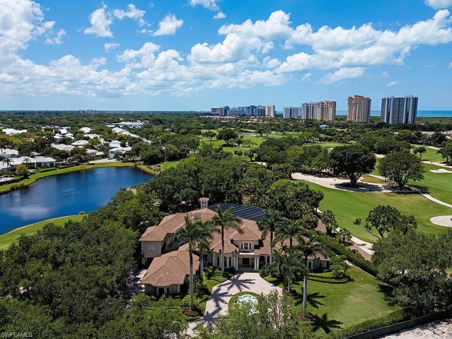Perched on a point lot within the prestigious gates of Pointe Verde at Pelican Bay and framed by majestic palms, this entirely custom residence designed by Eric Brown features a grandeur aesthetic and remarkable architecture.