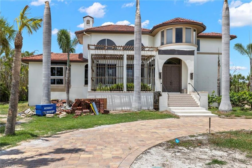 Behind the private gates of West Gulf Drive's only gated community and just across the street from the convenient deeded beach accesses is the coveted near-beach community of Butterknife. Backing up to a preserve with serene views this truly unique home boasts Spanish revival architecture in an idyllic near beach setting. The grand living room boasts two-story cathedral ceilings, fireplace, a view of a garden out front and the beautiful pool area out back. The large kitchen overlooks the preserve and the unique dining room was designed with a natural flair. The grand staircase leads up to the primary suite with large footprint, office, and bathroom with stunning preserve views. The large pool deck features a linear pool running perpendicular to the house with a hot tub and plenty of room for entertaining. A new Brava composite Spanish tile roof was just installed. The home was affected by Hurricane Ian and has been remediated down to the studs. This is an opportunity to rebuild a near-beach masterpiece.