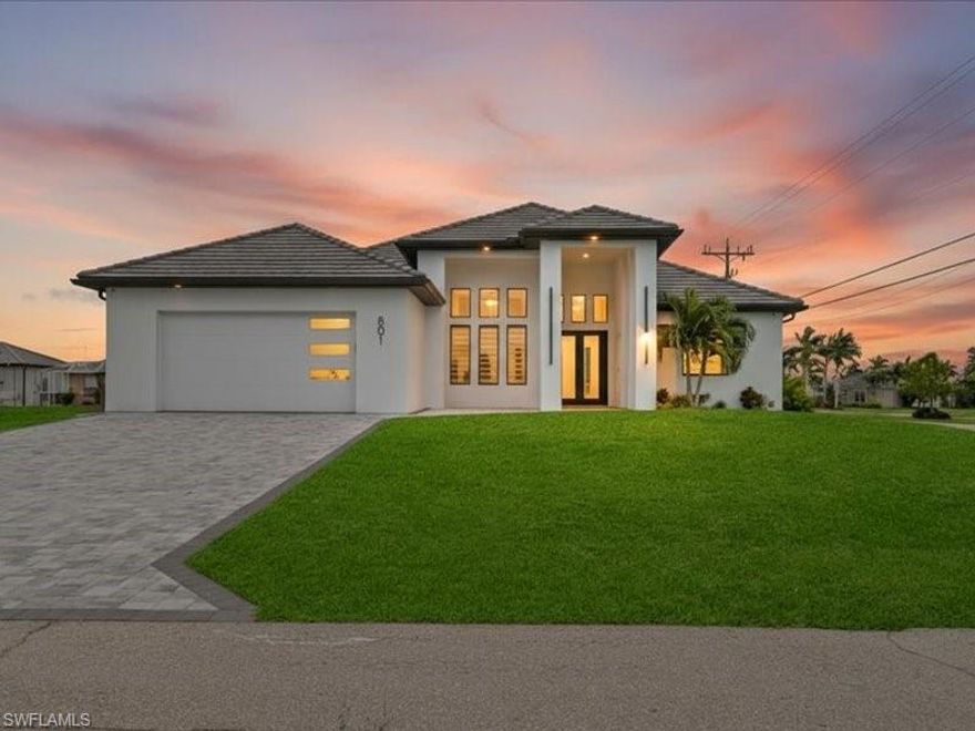 Luxury Lifestyle Living in highly desirable NW Cape Coral! Situated on a prime corner lot just two blocks from Tropicana Park and minutes from the highly anticipated Seven Islands Project, this extensively upgraded custom pool home offers exceptional quality, design, and functionality.

This 3 Bedroom + Den, 3 Bath residence features 2,240 sq ft of living area (4,785 total sq ft) with an open-concept floor plan designed for entertaining and everyday comfort. The home showcases a slate tile roof, soaring ceilings, and 8-foot interior doors throughout, enhancing the spacious feel. Coffered ceilings in all bedrooms and LED accent lighting in the living room and primary suite add elegant architectural detail.

Tile flooring runs throughout, including durable 8x46 wood-plank tile installed over concrete for enhanced stability and longevity. A stunning store picture window creates a dramatic focal point and fills the home with natural light. All windows and doors are impact-resistant, and zebra blinds are installed throughout.

The chef’s kitchen features custom-built modern cabinetry, quartz surfaces, and black stainless-steel appliances by Bosch.

Outdoor living is truly impressive with approximately 2,000 sq ft of screened lanai space featuring pavers, 90-degree sliding glass doors for seamless indoor/outdoor flow, and a 13x33 resort-style pool complete with sun shelf, dual bubblers, waterfall, and decorative water bowls. The fully equipped outdoor kitchen includes quartz countertops and premium appliances by Bull Outdoor Products.

Additional premium features include:
• 499 sq ft garage with epoxy-finished flooring
• 250-gallon whole-house reverse osmosis system
• 22-speaker surround sound system with subwoofer (interior and lanai) 4 amps.
• App-controlled audio system
• 8 exterior security cameras
• Floating custom bathroom vanities
• Custom built-in closets in every bedroom and pantry
• Foam-insulated concrete walls for energy efficiency, moisture resistance, and mold prevention
• Paver driveway
• Furniture negotiable

This home is loaded with upgrades and offers a rare combination of luxury finishes, smart features, and resort-style outdoor living in one of NW Cape Coral’s fastest-growing areas. Schedule your private showing today.