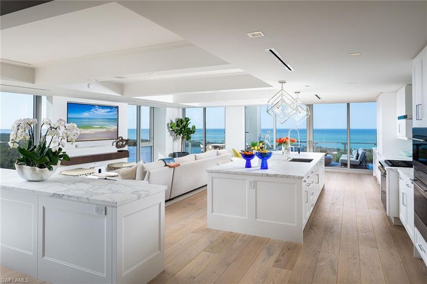 Perched on the 15th floor, this exquisite FURNISHED end unit in Mystique effortlessly blends modern architecture with timeless design. Expansive floor-to-ceiling windows frame breathtaking southern views of the Gulf of Mexico and the shimmering coastline creating a stunning backdrop for every room. The residence showcases chic, transitional ceiling details, refined lighting, and impeccable finishes, delivering an ambiance of understated luxury. Designed for effortless entertaining, the spacious kitchen flows seamlessly into the open-air lanai with glass railings, offering the perfect vantage point to enjoy the spectacular views. A bar island with dual wine coolers further enhances the home's entertaining appeal. The primary suite is a true sanctuary, featuring a serene view of the estuary, a spa-like bathroom with a freestanding tub and luxurious shower, and an exceptional custom-designed closet. Equipped with state-of-the-art Savant and Lutron smart home technology, this meticulously crafted residence leaves no detail overlooked. Situated in the prestigious Mystique high-rise, this home offers a rare opportunity to experience the ultimate in Pelican Bay living.