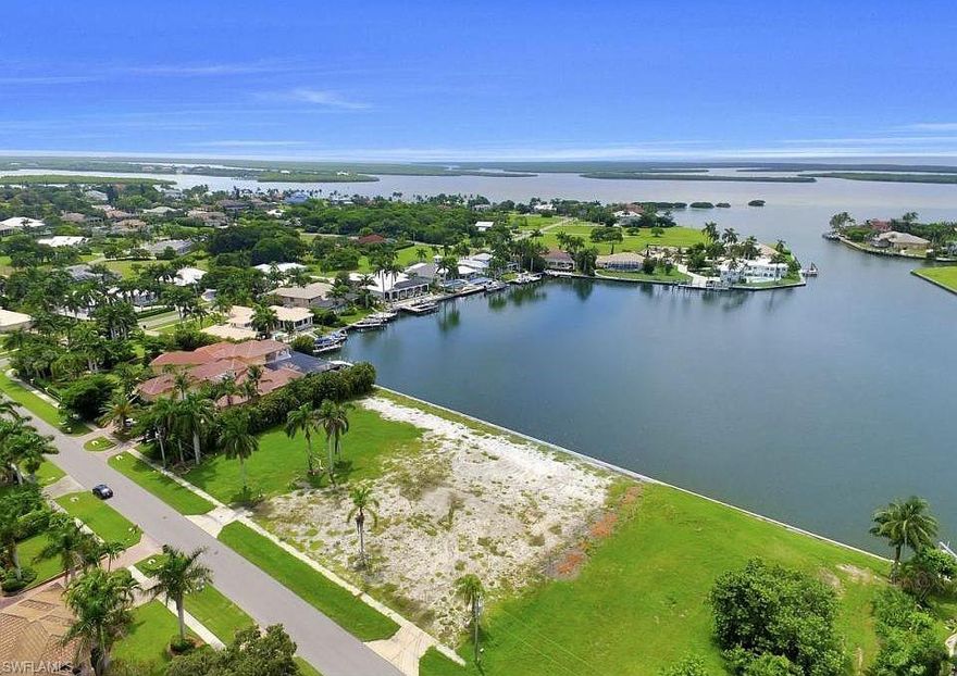 Rare opportunity to own a generous 0.5-acre canal-front lot in the highly sought-after Marco Island community. This spacious rectangular lot offers approximately 125 ft of waterfront with approximately 175 ft depth, providing ample space to build your dream home with direct, unobstructed access to the Gulf of Mexico via a wide navigable canal—perfect for boating enthusiasts. Enjoy serene water views and the tranquility of island living while being just minutes from Marco Island’s pristine beaches, shopping, dining, and world-class amenities.
The lot currently features natural vegetation and offers a blank canvas for customization. No bridges restrict your boat access to the Gulf, ensuring smooth sailing for your vessels. Zoned for residential use, this prime parcel is ideal for building a custom estate or vacation retreat. Photo is dated and from third party, but does represent view of Fredrick’s Bay.