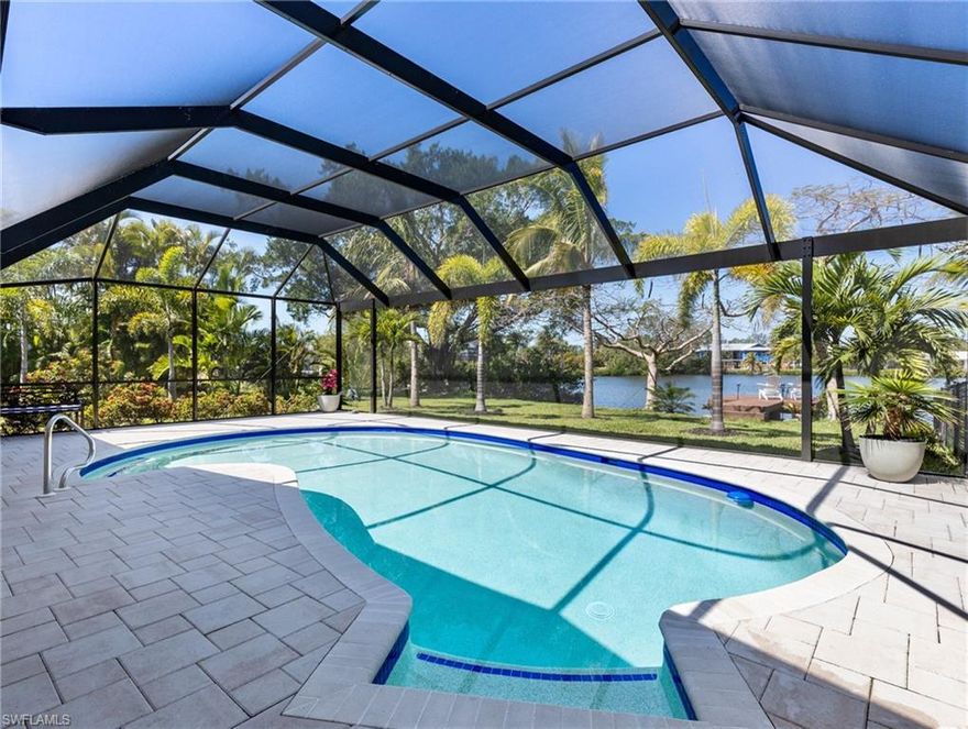 Stunning Sunsets are “included” with this lakefront masterpiece home! Feel the “wow factor” as you step inside this 3 bedroom + den pool home that’s nestled on over 1 acre in the heart of South Fort Myers.  Perfectly positioned along an expansive lake with breathtaking views, this home is designed for the most discerning buyer.  The owners spared no expense - showcasing $400,000 to renovate the home from the studs out with impeccable craftsmanship and high-end finishes throughout. The open, light-filled floor plan with lake views from every room creates a seamless blend of comfort and sophistication, enhanced by neutral designer paint tones and tile flooring that flows throughout the entire home. The kitchen is a true centerpiece with a full-slab quartz waterfall island with generous seating —perfect for gathering and entertaining. Features include a designer backsplash, farmhouse sink, brand-new appliances, wine cooler, pantry, soft-close cabinetry, crown molding, and LED lighting under the cabinets. The thoughtfully designed split-bedroom layout ensures privacy, with each bedroom offering tranquil lake views. The expansive primary suite measures over 16x16 and provides a true retreat. The spa-inspired en-suite bath features quartz countertops and a luxurious rainfall shower. A spacious custom walk-in closet completes the suite. Step outside to your own tropical paradise set on over an acre of beautifully reimagined grounds. The redesigned enclosed lanai has been upgraded for elevated outdoor living, offering two separate sitting areas ideal for entertaining. The fully renovated pool boasts new tiles, pavers and coping, resurfaced interior, LED color-changing lighting, super screen fabric, and a picture screen cage. Three sets of Impact glass sliders add protection and peace of mind. The lush, mature landscaping is extraordinary, featuring a variety of palms and flowering trees along with multiple tree swings. A fenced area provides a safe play space for pets, while a large, tiled pad tucked beneath the trees creates a serene Zen-inspired sanctuary. The brand-new composite dock is the perfect place to watch the sunset, launch a kayak, or cast a line. Additional upgrades include a 2024 roof, A/C, new water heater, new pool heater 2026, plus all-new re-piped plumbing and updated electrical, foam insulation, and whole-yard irrigation. Truly move-in ready, there is absolutely nothing to do but move in and enjoy. Located in the highly desirable Heritage Farms Lake Addition in South Fort Myers, just minutes from Lakes Park, this property delivers the perfect balance of seclusion and convenience. And, there's plenty of extra space to park your RV, Boat, or toys!  Plus, no HOA fees! Close to shopping, restaurants, white sand beaches and Southwest Florida International Airport, this extraordinary property delivers luxury, location, land, waterfront, and lifestyle—an exceptionally rare combination in the heart of South Fort Myers. You are now HOME!