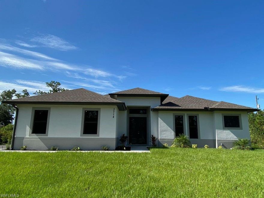 MOVE-IN READY HOME built in a 2.27 acres 100% upland lot, in the area of Golden Gate Estates,  features 3 bedrooms + Den, 2.5 bath, & 2 car garage! Living area of 1,900 sq.ft and a grand total of 2,627 sq.ft. Upgrades include 24x24 porcelain tile throughout, crown molding, quartz countertops, stainless steel appliances, and solid wood cabinets! The living room and master suite boasts tray ceilings. Master wing features an oversized bedroom, 2 spacious closets, double vanity, and glass door enclosed shower. The outside of this home will not disappoint either with a Summer Kitchen and a beautiful landscape, auto sprinkler system, and a large lanai. Impact resistant windows/doors! Whole house reverse osmosis included in price.