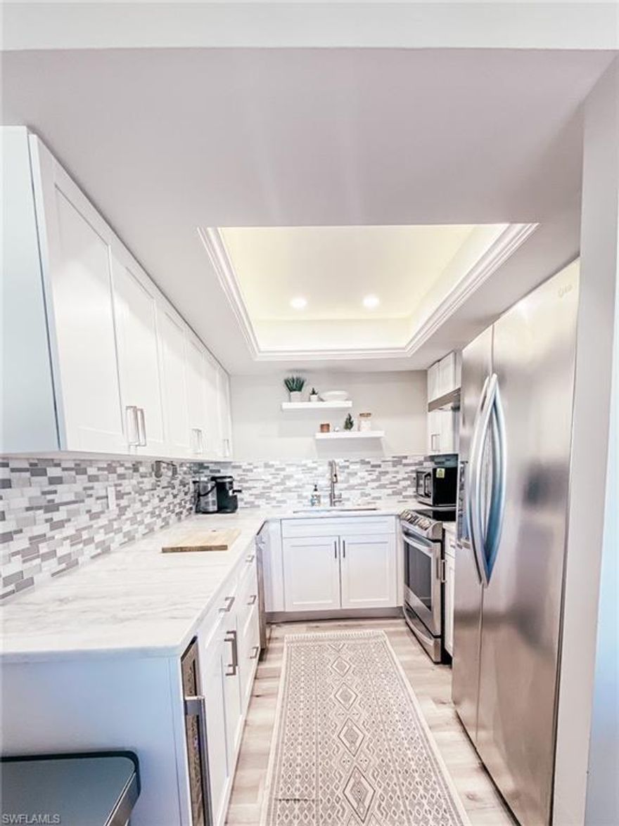 UPDATED UNIT in this GOLFING PARADISE. Low fees of $753/month include golf and all amenities. Complete remodel in chef's kitchen complete with stainless steel appliances, beautiful granite countertops, wine cooler, pot filler. Both bathrooms updated with tile flooring. Wood-like luxury vinyl floors in the living areas. All woodwork is brand new including kitchen cabinets, crown moldings, baseboards and doors. New water heater and a/c.