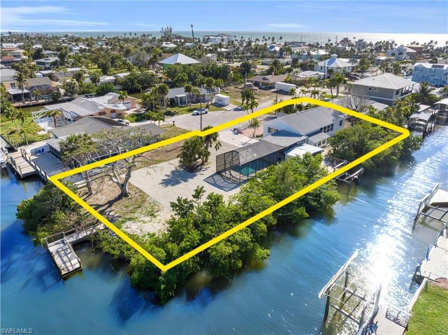 OVERSIZED .38 ACRES Waterfront Pool home - Boater’s Dream Meets FMB Bliss! TWO Canals for Boat docks. ROOM to Build an ACCESSORY UNIT on this expansive lot and keep the existing waterfront home. Boat in to a dozen bars & restaurants in the Pier District in 5 minutes. Are you ready to fall in love with this one-of-a-kind waterfront retreat offering an incredible 266 feet of water frontage! With dual-sided access and room for multiple docks, this property is truly built for those who live life on the water — from early-morning fishing runs to sunset cruises along the Back Bay. Set on a sprawling 16,640 sq ft (.38 acre) parcel, this partially elevated 3-bedroom POOL home has been beautifully updated and is ready for new memories. Step inside and discover a bright, open layout with NEW electric, NEW appliances, NEW roof, and a fully remodeled kitchen featuring a large island that brings everyone together. The split-bedroom floor plan offers flexibility for large families or short-term rentals, and the abundance of windows floods the home with natural light and serene water views. Out back, you’ll find your own private oasis — a 25-foot-long pool perfect for parties or peaceful morning laps. The oversized screened lanai features a covered patio, storage space, and views of your dock and boat lift. There’s room to expand, entertain, and play — think yard games, extra parking, or even hosting waterfront events on your oversized lot. Anglers will love the TWO docks, and beachgoers will appreciate being just an 8-10 minute walk to multiple beach access points. Tucked away in a quiet neighborhood yet close to the Pier District, Margaritaville, and Times Square, you’ll enjoy the perfect mix of privacy and proximity. This rare slice of Fort Myers Beach paradise is now priced to move. Bring your boat, bring your vision, and start living your best coastal life today!