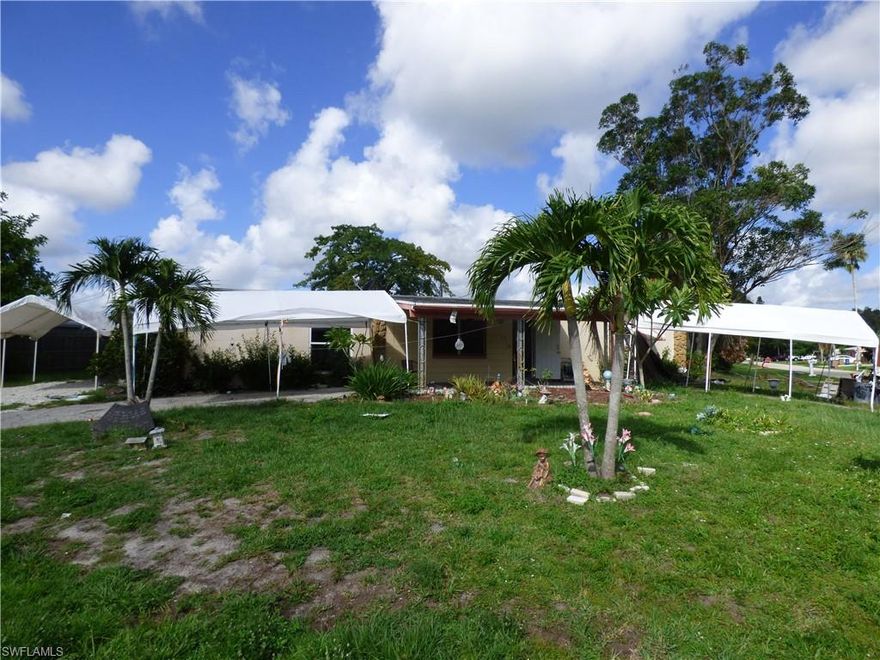 Three bedroom, two bath fixer upper on an oversized corner lot with central water and sewer, newer laminate floors, 1280 square feet of living area, newer 200 amp electrical panel box, two screened lanais, walking distance to stores and minutes to I-75 and Ft Myers.