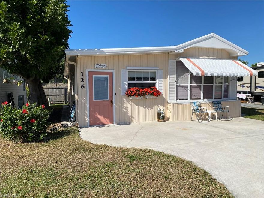 You are going to love this cozy, cute little home!  It has been very nicely decorated just perfectly for the Naples area.  It is located in an active, gated, 55 plus community where you OWN the land. This area is truly a hidden gem in East Naples. It has been well maintained with the gentleman of the house making sure that things were up to snuff with his workshop in the rear of the home.  This room also functions as the laundry area. It is located directly across from one of the two beautiful pools that this community has! Concerned about noise?  Don't be!  The fence and shrubbery around the pool mute the sound and you get the benefit of having a pool and hot tub just steps away.