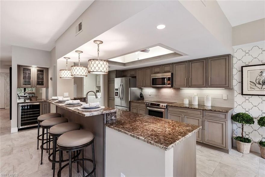 Introducing a quietly nestled home in the Oakwood community of Bonita Bay. This home offers an open floor plan with three bedrooms, three en-suite bathrooms and a two-car garage. A spacious lanai overlooks a serene lake and lush preserve. Enjoy a beautifully remodeled kitchen featuring granite countertops, subway tile backsplash with glass accents, and a full stainless steel appliance package, including a built-in wine cooler. Owners have the option of obtaining membership at the world-class Bonita Bay Club, which includes access to five championship golf courses, eighteen tennis courts, a state-of-the-art fitness center, and a resort-style pool with multiple dining options. Residents of Bonita Bay have access to a private beach park on the Gulf of Mexico, including over 12 miles of trails, three parks, additional tennis and pickleball courts, and a full-service marina.