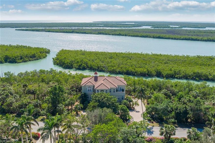 Classic Florida waterfront estate, beautifully designed/maintained. Natural high elevation (first-floor living-25'above sea level). Sweeping views of Caxambas Bay & Little Tide Key. Coveted southern exposure, .5-acre lot bordering protected coastline in the 10,000 Islands. Complete privacy on the first-floor pool terrace, shielded from view and protected by vast mangroves. One of only a few lots in this gated community with high elevation, southern exposure & stunning water views. Adjacent lot is negotiable with this sale. Refined indoor/outdoor coastal living with multiple terraces and spectacular views of the natural habitat, sunrises/sunsets. Featuring two master suites, three guest bedrooms, two offices, home theater and large recreation/media area. Oversized pool/spa, sauna, outdoor kitchen & fireplace. AC storage room. 5-car garage. Owner is a master gardener and created a lush, private retreat incorporating native & edible plants and multiple gardens that are all low maintenance with minimal chemical usage. Sense of serenity and supreme privacy is what makes Key Marco so special. Direct-access boat slip, renovated clubhouse with gym, tennis courts and walking/biking trails.