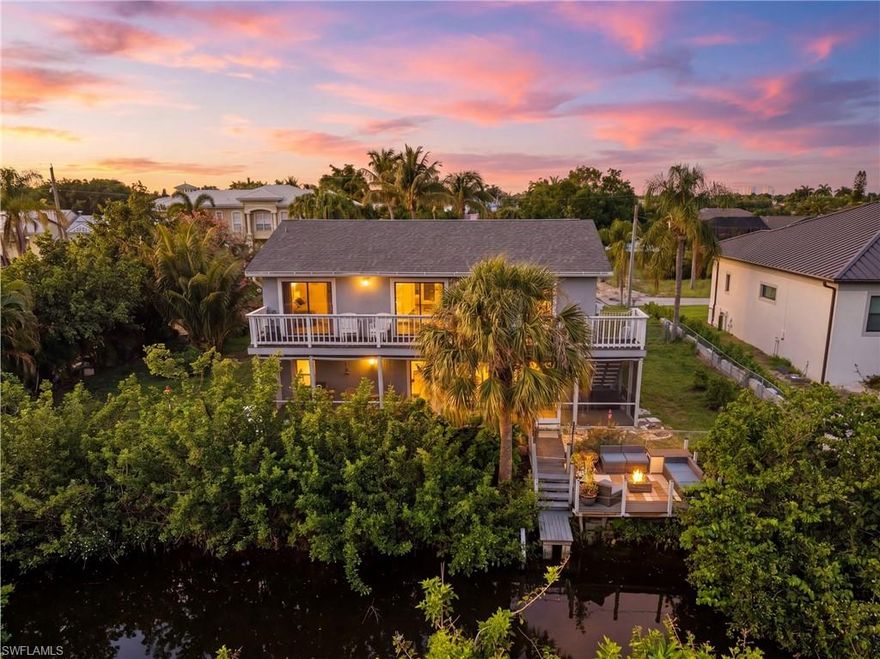 GULF ACCESS. NO HOA. 3 BED+DEN. 3 FULL BATHS. OVERSIZED GARAGE. JUST MINUTES TO THE HEART OF DOWNTOWN BONITA SPRINGS and on a street where vacant lots alone are selling for $400K+. Located just 3 minutes from Downtown Bonita Springs and local hotspots, with quick access to Coconut Point, RSW Airport, and SWFL's beaches, by car or by boat. Step outside to your oversized, fully fenced WATERFRONT yard lined with palm trees and 8 citrus trees.  Add your dream pool, expand your outdoor living, or simply enjoy the space. The expansive screened lanai opens wide to capture incredible breezes off the water, all overlooking your canal with DIRECT ACCESS to the Gulf of Mexico. Relax on your private composite deck, watch manatees pass by, or design your dock and lift, this is true Florida boating life right from your backyard. Inside, with over 2,000 sqft of bright, open living space designed for both comfort and entertaining. The main level features upgraded wood-look ceramic tile and porcelain flooring throughout, a spacious living room, formal dining area, and an additional  flex/entertaining space perfect for a second living area/game room. The kitchen has been completely redone equipped with newer appliances, quartz countertops, custom cabinetry, a large island, oversized 4-door pantry, and wine rack. A versatile main-level flex room with its OWN closet and PRIVATE garage access offers the perfect 4th bedroom, guest suite, office, or gym, with a full upgraded bathroom featuring a walk-in shower conveniently located nearby. Upstairs, you’ll find 3 oversized bedrooms plus a spacious loft overlooking the main living area, ideal for a media room, workspace, or additional living space. EVERY bedroom features sliding glass doors leading to a second-story balcony overlooking the canal, along with a private exterior staircase for easy access after a day on the water. The primary suite is bright and spacious with balcony access, generous closet space, and an upgraded en-suite bath with granite vanity and walk-in shower. The guest bathroom upstairs is also generously sized with updated finishes and a tiled tub/shower combo. Additional highlights include an oversized circular driveway, large garage with storage, an oversized laundry room with sink, cabinetry, and folding space, and extra storage throughout the home. NO HOA. NO RESTRICTIONS. DIRECT GULF ACCESS FROM YOUR BACKYARD. Perfectly located in a safe, highly desirable area, this home is ideal as a primary residence, vacation property, or investment opportunity with no rental restrictions. If you’ve been waiting for the full Florida lifestyle—by land and by water—this is it.