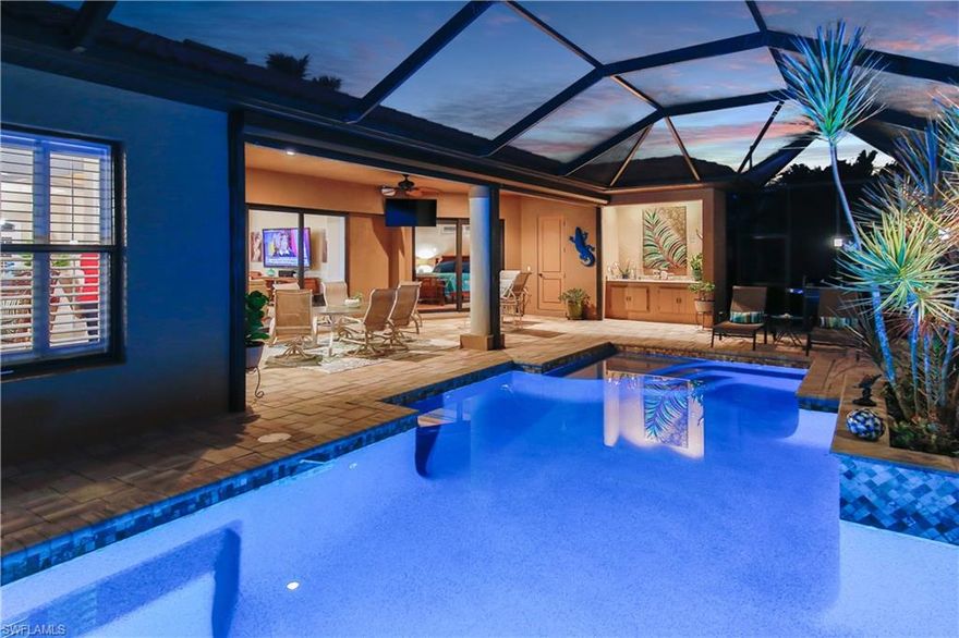 Southern exposure gulf access pool home with 2300+ sf with impact windows/doors located in a highly desired SW location of Cape Coral.  Impress your family and friends with this well maintained home with plenty of room for short term or long term visitors to stay in one of the four bedrooms.  Cook up your best recipes in the large kitchen that oversees the living area with granite counter tops, stainless steel appliances, wood cabinetry, pantry and breakfast bar with additional breakfast knook with pool and water views.  More formal occasions can be held in the formal dining room.  Enjoy the pool and water views from the living room with trey ceiling and recessed sliders.  Travertine tile throughout the main living area, crown molding, trey ceilings, recessed lighted displays and so much more.  The pavered pool deck encumbers a beautifully designed pool with waterfall and the screened pool cage lanai makes evening dinners by the pool a delight.  Mature landscaping, tile roof, oversized 2 1/2 stall garage, pavered driveway, canopy covered boat dock with boat lift, water/electric at dock, and Captain's Walk finish the exterior detail.  Call today to schedule your private showing!