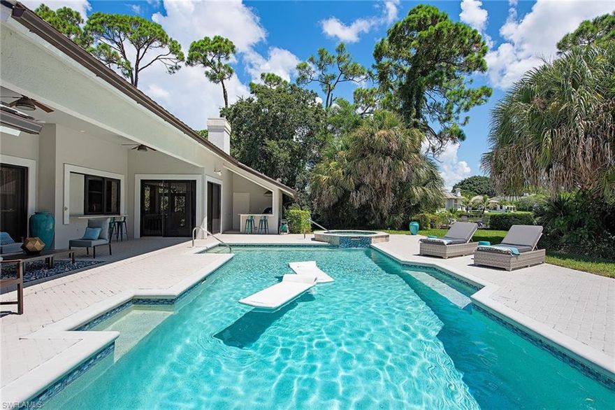 Gorgeous, extensively updated Pine Ridge single-family home on a large lot with stunning lake views. All on one level. Enter to formal living and dining space with custom built-ins. High and detailed ceilings feature beautiful designer lighting. A large open kitchen with a center island overlooks the family room with a fireplace, and French doors lead to a pergola terrace. Impact glass throughout, 2 tankless hot water heaters, Sonos/security system and more. Four generously sized bedrooms (two of which are master suites), den with fabulous built-in desk, four and a half baths plus detached three-car garage with guest house/flex space with additional full bath. Spectacular outdoor living surrounded by lush landscaping, serene backyard, pool, spa, paver deck, outdoor kitchen and full pool bath with shower. Boat with electric motor and canoe included. New roof 2020. Prime location minutes from Waterside Shops, shopping, dining, beach access and more.