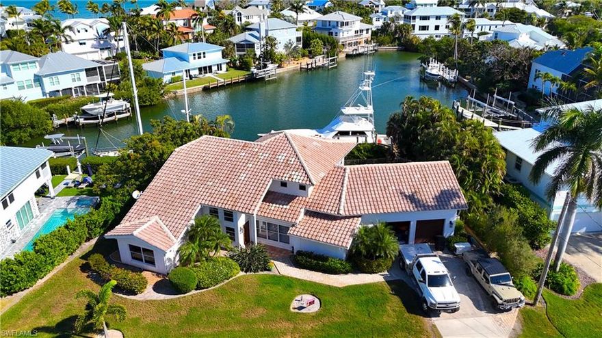 Welcome to your ultimate Sanibel Island getaway—designed for unforgettable stays and strong rental appeal. This spacious 4-bedroom, 4-bath waterfront home offers over 3,000 sq. ft. of bright, open living, perfectly suited for hosting families, groups, or seasonal guests. Set on a quiet, palm-lined street, the home delivers the ideal blend of privacy and accessibility. Inside, the open-concept layout is filled with natural light, featuring expansive living and dining areas that flow seamlessly into a well-equipped kitchen—perfect for entertaining or relaxing after a day on the water. Each bedroom is generously sized, offering comfort and privacy for guests, while four full bathrooms make it easy to accommodate larger groups. The primary suite serves as a private retreat, complete with a spa-style bathroom and oversized walk-in closet. Step outside to your own private resort-style setting. Enjoy the heated pool and hot tub, surrounded by lush tropical landscaping. Boaters will appreciate the 10+ ft deep canal with direct Gulf access and no bridges, along with a brand-new dock and lift—ideal for enjoying everything Southwest Florida waterfront living has to offer. Located just minutes from Sanibel’s renowned beaches, shelling, bike paths, and nature preserves, this property is perfectly positioned for high-demand vacation rental use.