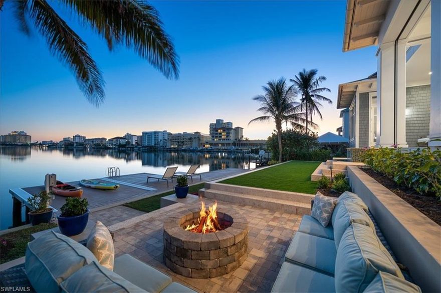 Discover the meaning of luxury living and one of the finest long water views in Conners. This enchanting residence, built in 2016, has long sweeping water views and highly-desirable southern rear exposure. This Sand Dollar Award winning masterful collaboration between Stofft Cooney and BCB Homes is sure to delight even the most discerning buyer. The spacious great room floor plan with voluminous ceilings leads to a covered lanai with hidden motorized screens, summer kitchen, open-air dining area, infinity edge spa, fire-pit, and dock with a platform lift for true indoor-outdoor living. The first-floor primary retreat features a spa-like ensuite and a generously sized walk-in closet. On the second level an oversized study, which could be a fifth bedroom, and additional guest bedrooms and baths provide comfortable accommodations for owner and guests alike. Located just steps from Vanderbilt Beach off Gulf Shore Drive, this is a fantastic home for beach lovers and boaters alike. This an exciting opportunity is not to be missed!