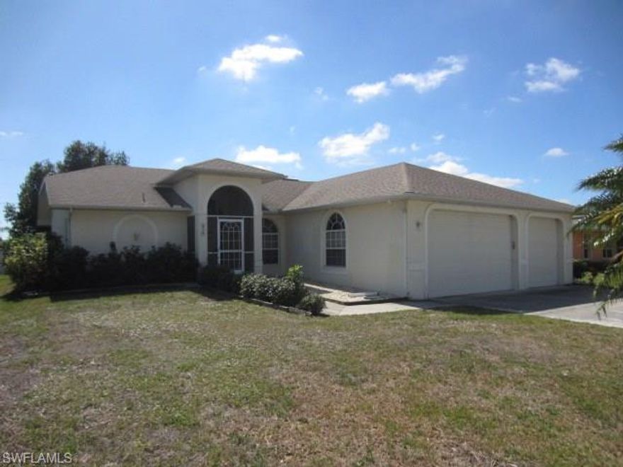 Amazing 3BR/2BA/3 CAR GARAGE home in Central Cape Coral close to public and private services! Exterior shows awesome back yard with space to relax and play in the midst of Fantastic shade trees all prepared for enjoying the true  outdoor South Florida lifestyle. Interior is spacious with soaring cathedral ceilings, planter shelves and open living area with separate dining! ALL TILE floors, UPGRADED KITCHEN, spacious Master Bath with Dual Sinks are among the features that make this home a "top of the list" winner. Don't delay-Schedule a showing TODAY!